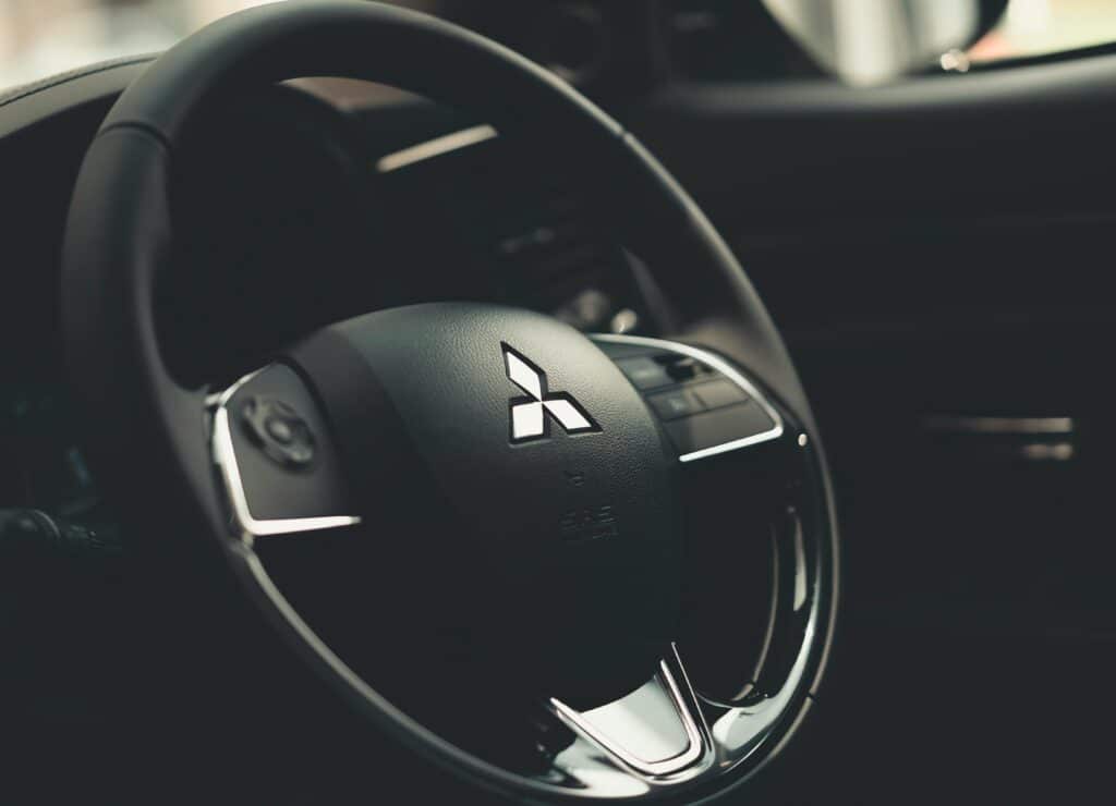 Intricate details of a Mitsubishi steering wheel with a focus on texture and design.